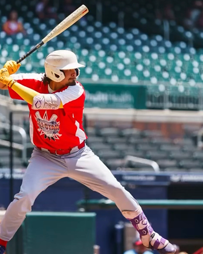 PHC coach mid-swing in red uniform