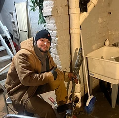Alfieri Brothers crew member giving a thumbs up after snaking a drain in a basement
