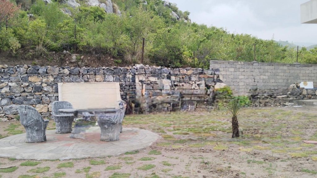 Stone-paved patio with sculpted seating at the Khanpur Dam farmhouse