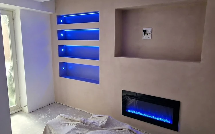 Bespoke media wall with integrated blue LED lighting and electric fireplace