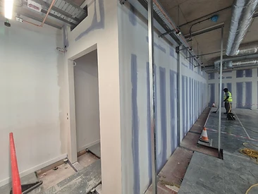 Partition wall with jointed seams and a metal stud frame in front of a doorway opening