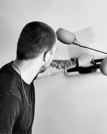 Kieran P Blanchard working on a wall with a trowel