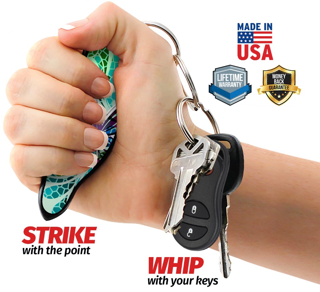 Hand holding a MUNIO Self Defense keychain, with the pointed striking tip and connected keys