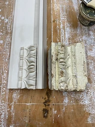 A newly cast plaster enrichment beside an original weathered fragment