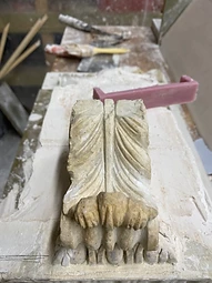 A modillion block being repaired in the workshop