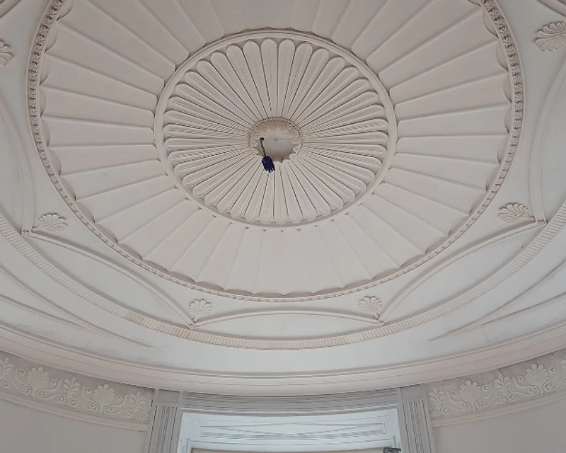 Low-angle view of a classic circular plaster ceiling rose