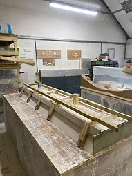 The bench set up for silicone to be poured, producing the rubber mould