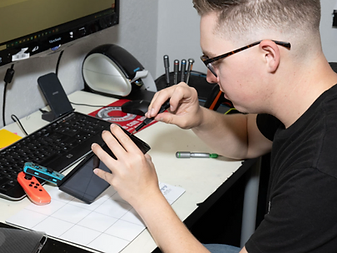 Aiden repairing electronics at his workbench