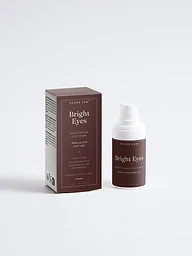 Bright Eyes brightening peptide eye cream bottle and carton on mahogany backdrop