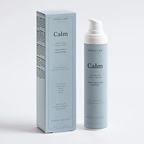 Calm soothing face cream bottle and carton on dusty blue backdrop