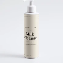 Milk Cleanse gentle cleansing milk bottle on bone linen backdrop with cream texture