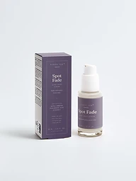 Spot Fade dark spot serum bottle and carton on deep mauve backdrop