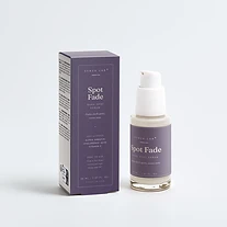 Spot Fade dark spot serum bottle and carton on deep mauve backdrop