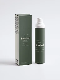 Rewind peptide firming face cream bottle and carton on deep sage green backdrop