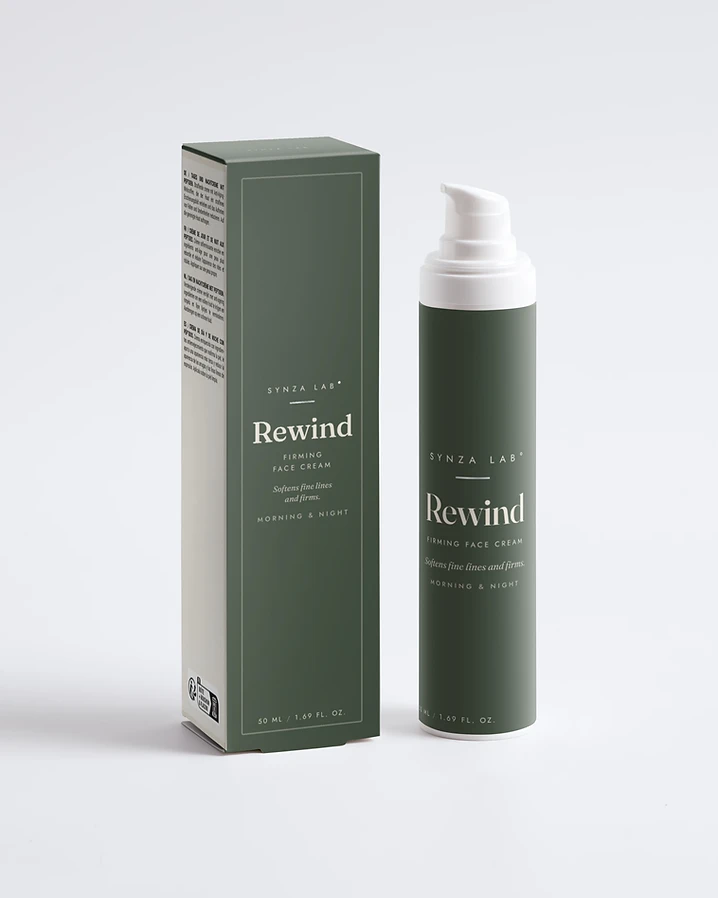 Rewind peptide firming face cream bottle and carton on deep sage green backdrop