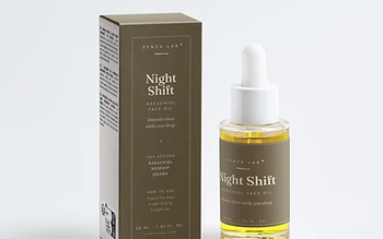 Night Shift bakuchiol face oil bottle and carton on bronze backdrop in evening light