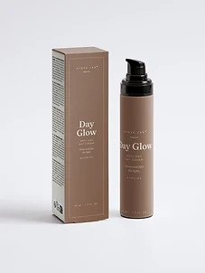 Day Glow anti-age day cream bottle and carton on warm brown backdrop