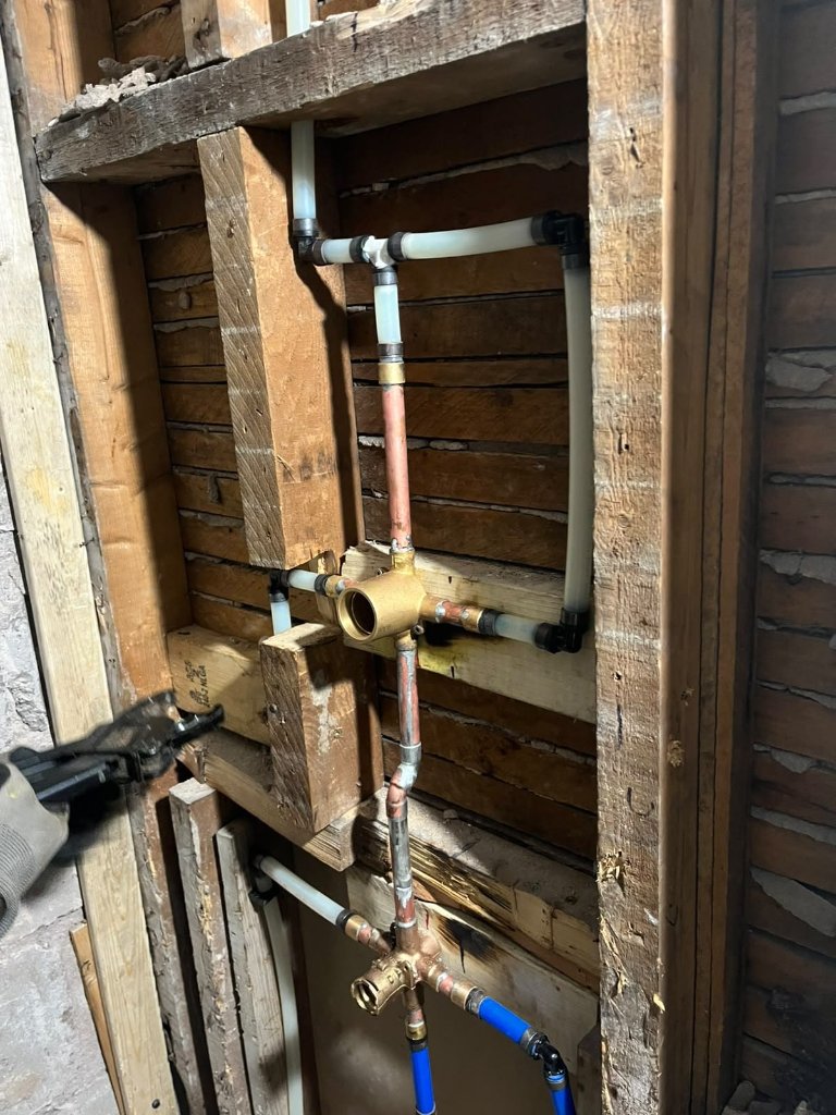 Black ABS drain stack routing during a stack repair.