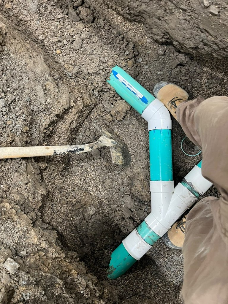 Commercial new construction — underground drain installation and slab prep.