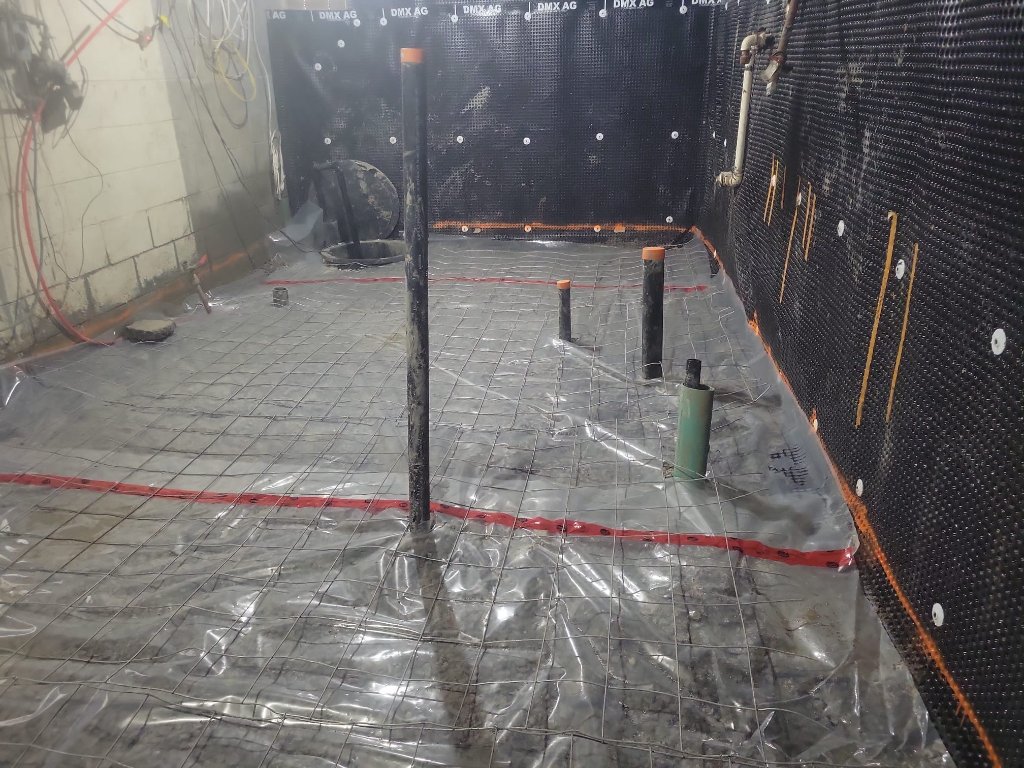 DMX AG waterproofing membrane installed against the foundation wall.