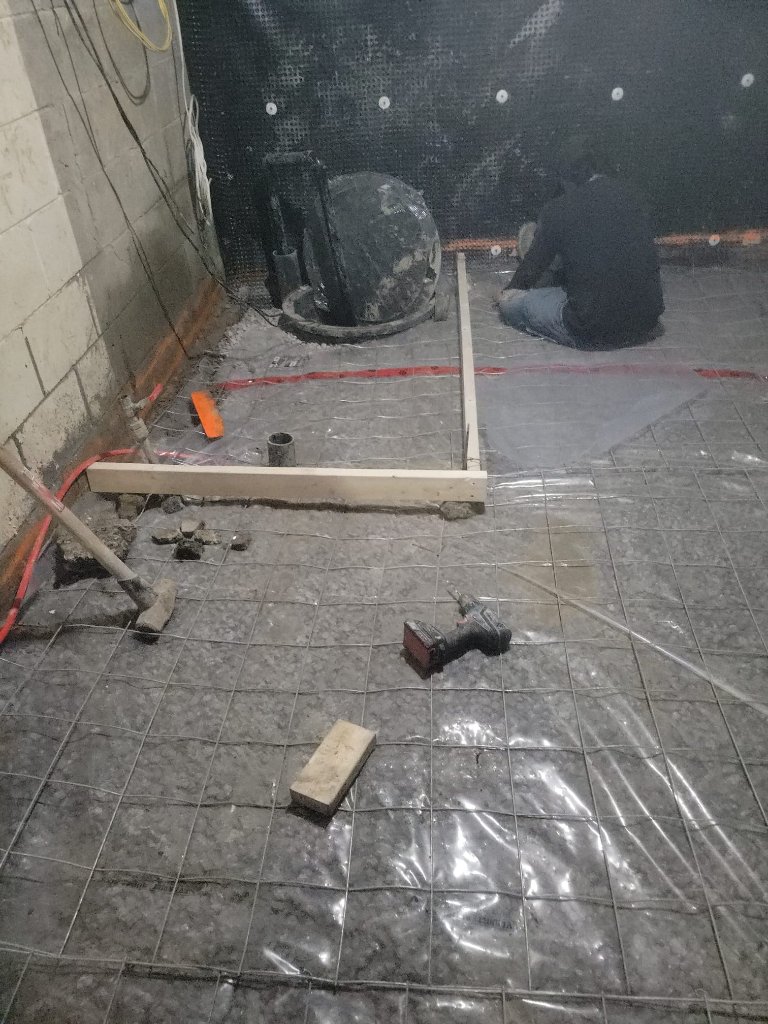 Finished basement waterproofing and drain rough-in, ready for concrete.