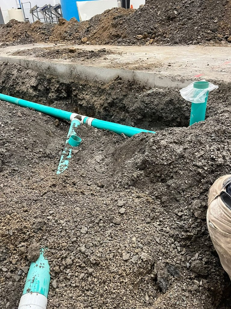 Commercial site drain rough-in ahead of the slab pour.