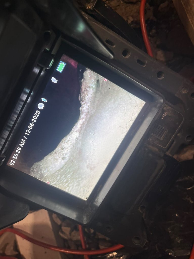 Blocked-drain diagnosis on a commercial job, ahead of new drain rough-in.