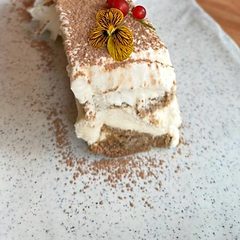 Tiramisu estilo italiano con cacao, grosellas y flor comestible