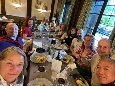 Community dinner gathering around a long table