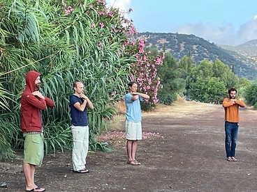 Four men practicing standing Qigong outdoors