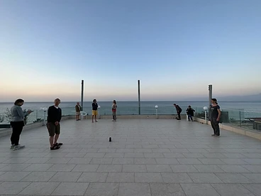 Group gathering on a rooftop terrace at dusk