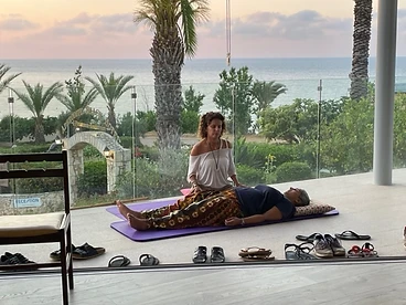 Qi therapy session on a stone balcony at sunset