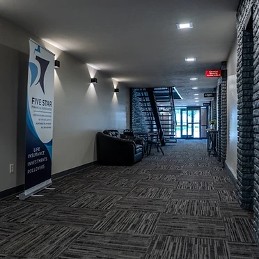 Building hallway with tenant signage and brick archways