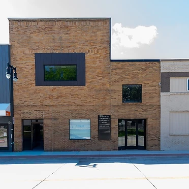Building facade with neighboring storefronts on 4th Avenue
