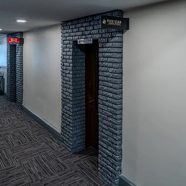 Hallway with charcoal brick archways and professional signage
