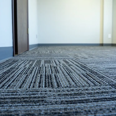 Commercial carpet tile and baseboard detail
