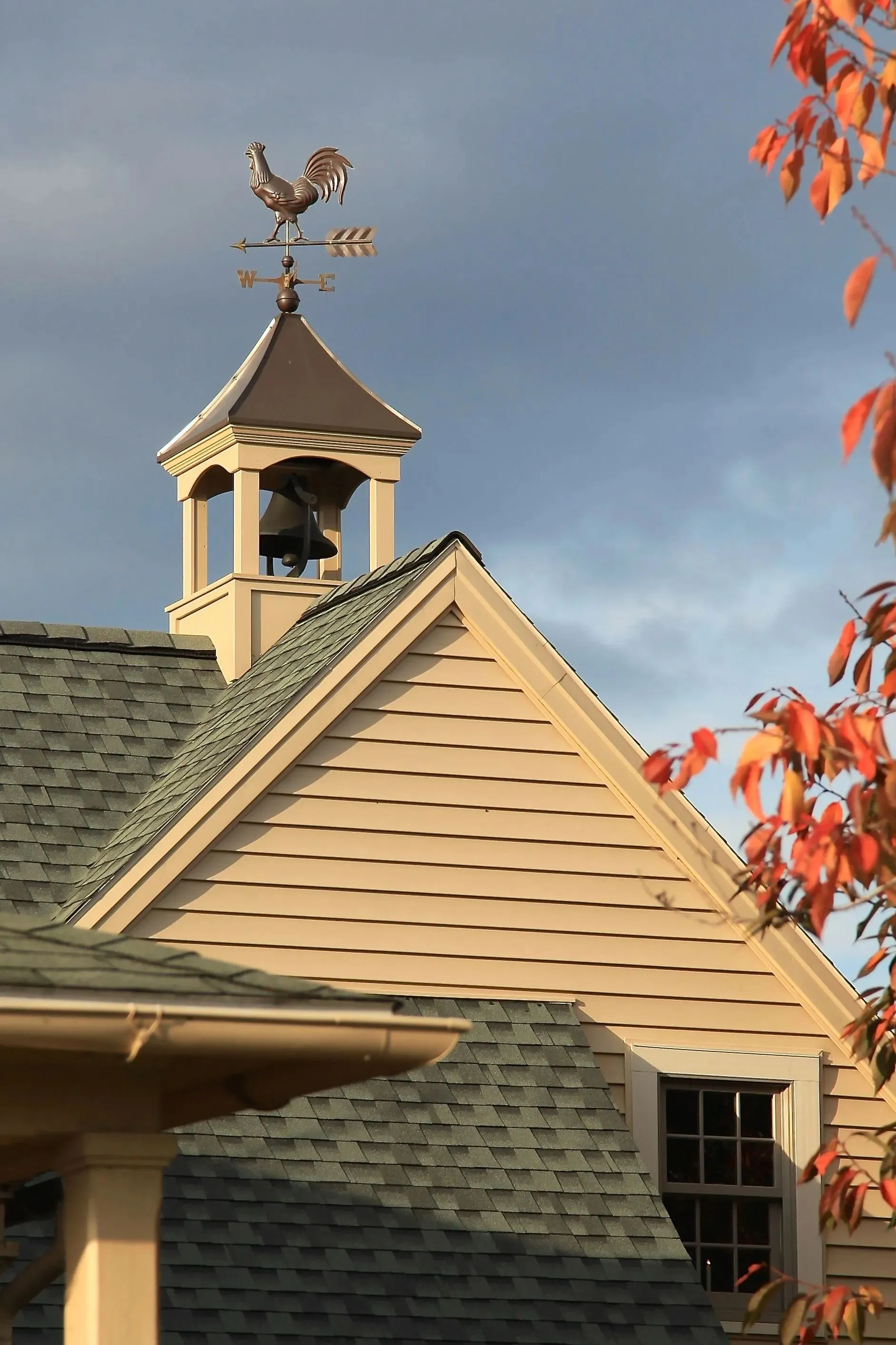 Cupola with a rooster weathervane against an autumn sky
