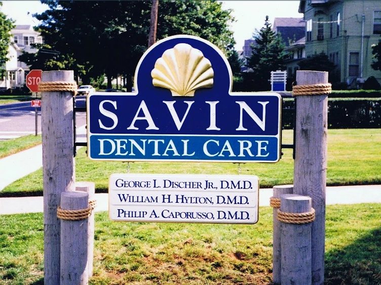 Free-standing hand-carved dental sign with gold shell emblem, finished in HDU with a durable navy and white paint scheme