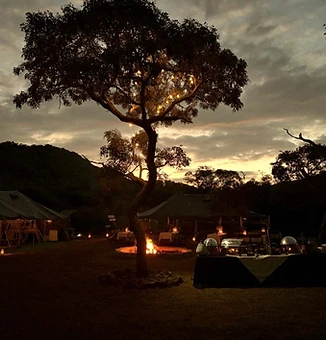 Dusk settling over the lantern-lit camp