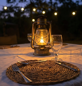 Lantern-lit table settings in the boma