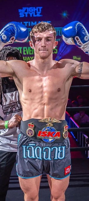 Max Manley victorious in the ring with championship belt