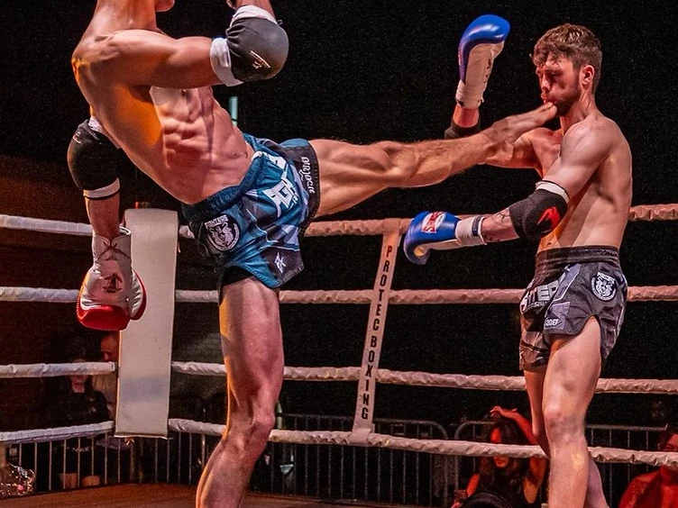 Max Manley landing a roundhouse kick in competition