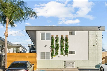 White modern multifamily building with vertical planters at 4665 34th Street, San Diego