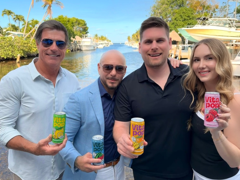 Pitbull and the Vita Pop crew holding cans in Miami