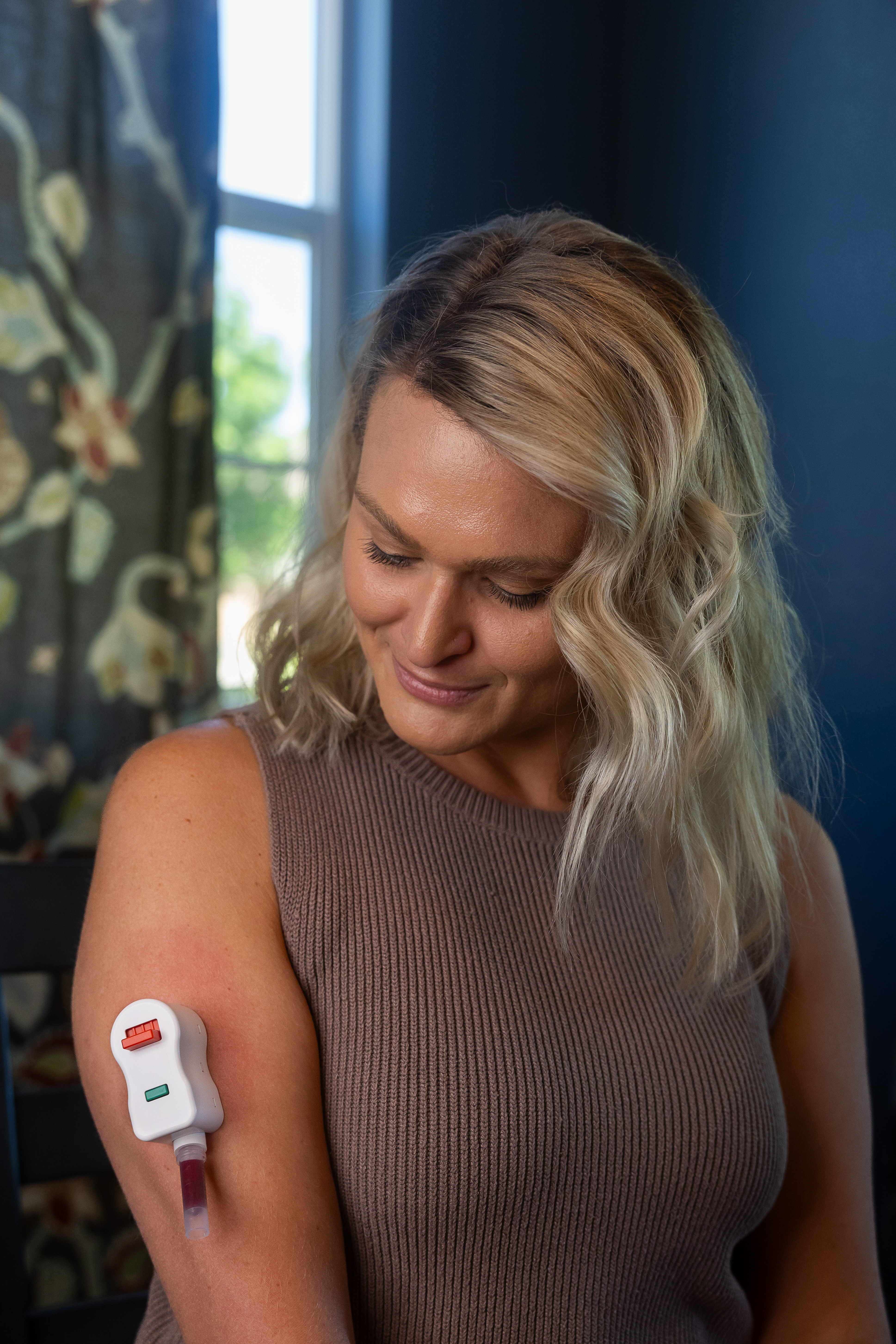 Woman using an at-home blood collection device
