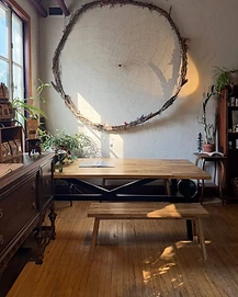 Large woven wreath hanging over the SOHA Studio dining table