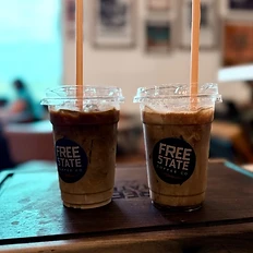 Two iced coffees on the wooden serving board