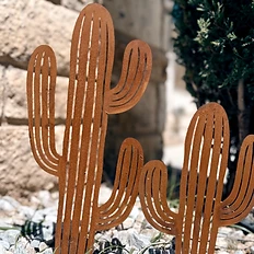 Rusted metal cactus sculptures in the garden bed