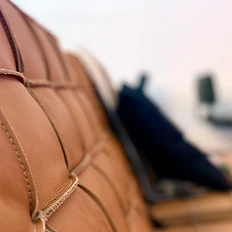 Close-up of tan tufted leather sofa upholstery