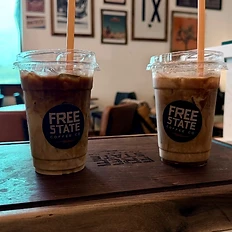 Two iced coffees on the Free State serving board
